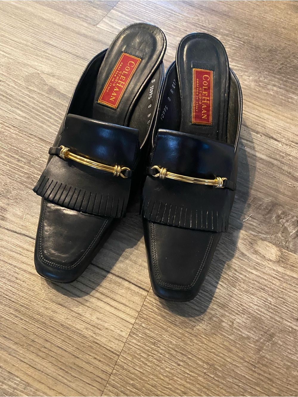 Cole Haan Black Leather Fringe Slip-On Mules with Gold Bar